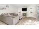 Comfortable living room with a fireplace, built-in shelving, gray sofa, and light wood flooring at 435 Summerwalk Cir # 435, Chapel Hill, NC 27517