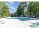 Community pool surrounded by lounge chairs and greenery, perfect for relaxation at 435 Summerwalk Cir # 435, Chapel Hill, NC 27517