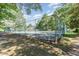 Fenced community tennis court surrounded by tall trees offering shade and privacy at 435 Summerwalk Cir # 435, Chapel Hill, NC 27517