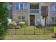 Serene fenced backyard with lush lawn and manicured bushes near the townhome at 453 Panorama Park Pl, Cary, NC 27519