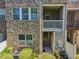 Close-up of townhome's backyard with AC unit, flowers, and an outdoor access door at 453 Panorama Park Pl, Cary, NC 27519