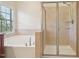 Bathroom featuring a garden tub and glass shower with tile accents at 453 Panorama Park Pl, Cary, NC 27519