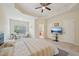 Bedroom featuring a tray ceiling, seating area, and bathroom access at 453 Panorama Park Pl, Cary, NC 27519