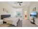 Bright bedroom with a TV, access to the bathroom and a seating area by the window at 453 Panorama Park Pl, Cary, NC 27519
