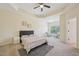 Spacious bedroom featuring tray ceilings, a ceiling fan, and a cozy seating area at 453 Panorama Park Pl, Cary, NC 27519
