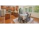Bright eat-in kitchen and dining area with wood cabinets, stainless appliances, and natural light at 453 Panorama Park Pl, Cary, NC 27519
