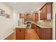 Modern kitchen featuring stainless steel appliances, granite countertops, and beautiful wood flooring at 453 Panorama Park Pl, Cary, NC 27519