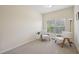 Sitting area with two chairs by a window and bright neutral colored walls at 453 Panorama Park Pl, Cary, NC 27519