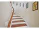 Elegant curved staircase with wood accents and decorative wall art at 453 Panorama Park Pl, Cary, NC 27519