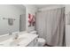 Bright bathroom features a vanity, mirror, and a shower with a decorative curtain at 4533 Pale Moss Dr, Raleigh, NC 27606