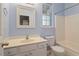 Bathroom with a vanity, large mirror, and a combined shower and tub area, illuminated by natural light at 4533 Pale Moss Dr, Raleigh, NC 27606