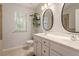 Bathroom featuring double sink vanity, tiled floor, and neutral decor at 4533 Pale Moss Dr, Raleigh, NC 27606
