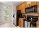 Well-lit kitchen featuring wood cabinets and a full suite of appliances at 4533 Pale Moss Dr, Raleigh, NC 27606