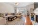 Bright living room with hardwood floors, large windows, and cozy fireplace at 4533 Pale Moss Dr, Raleigh, NC 27606