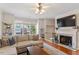 Cozy living room with fireplace, hardwood floors, and plenty of natural light at 4533 Pale Moss Dr, Raleigh, NC 27606