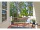 Charming porch with stylish furniture and a view of lush trees, offering a peaceful outdoor retreat at 4533 Pale Moss Dr, Raleigh, NC 27606