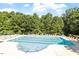 Community swimming pool with neatly arranged lounge chairs in a wooded setting at 4533 Pale Moss Dr, Raleigh, NC 27606