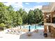 Beautiful community swimming pool and lounging area with tables, chairs, and umbrellas at 4533 Pale Moss Dr, Raleigh, NC 27606