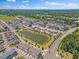 An aerial view of a meticulously planned community with a pond, green spaces and manicured lawns at 4716 Crescent Square St # 1314, Raleigh, NC 27616
