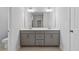 Neutral toned bathroom featuring a double vanity with gray cabinets and white countertops at 4716 Crescent Square St # 1314, Raleigh, NC 27616