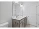 Bathroom featuring double vanity, large mirror and white door at 4716 Crescent Square St # 1314, Raleigh, NC 27616