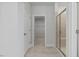 Hallway view of tiled floors, walk-in shower with glass door, and walk-in closet at 4716 Crescent Square St # 1314, Raleigh, NC 27616