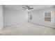 Bright bedroom features tray ceiling, ceiling fan, neutral walls and carpet at 4716 Crescent Square St # 1314, Raleigh, NC 27616