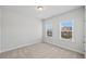 Neutral bedroom featuring two windows providing natural light and neutral carpet at 4716 Crescent Square St # 1314, Raleigh, NC 27616
