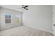 Bright bedroom with carpet, two windows, a ceiling fan, and neutral walls, ready for personalization at 4716 Crescent Square St # 1314, Raleigh, NC 27616