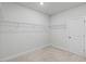 A white closet with overhead shelving and neutral carpeting at 4716 Crescent Square St # 1314, Raleigh, NC 27616