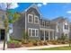 Attractive two-story gray home with white trim and colorful landscaping at 4716 Crescent Square St # 1314, Raleigh, NC 27616