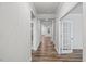 Spacious hallway with hardwood floors and white trim throughout at 4716 Crescent Square St # 1314, Raleigh, NC 27616