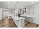 Bright kitchen featuring a center island, gray cabinets, stainless steel appliances, and wood flooring at 4716 Crescent Square St # 1314, Raleigh, NC 27616