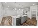 Spacious kitchen with center island, stainless steel appliances, pendant lights, and open layout to living space at 4716 Crescent Square St # 1314, Raleigh, NC 27616