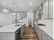 Well-lit kitchen with granite countertops, pendant lighting, stainless steel appliances, and gray cabinets at 4716 Crescent Square St # 1314, Raleigh, NC 27616