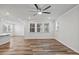 Bright living room features hardwood floors, a ceiling fan, and a large window offering natural light at 4716 Crescent Square St # 1314, Raleigh, NC 27616