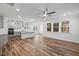 Bright open floor plan featuring hardwood floors, ceiling fan, and open view to the kitchen at 4716 Crescent Square St # 1314, Raleigh, NC 27616