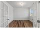 A home office showcasing hardwood floors and double French doors at 4716 Crescent Square St # 1314, Raleigh, NC 27616
