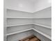 Walk-in pantry with built-in shelving and wood floors providing ample storage space at 4716 Crescent Square St # 1314, Raleigh, NC 27616