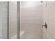 Close-up of the tile shower featuring a built-in seat and hand-held showerhead at 4716 Crescent Square St # 1314, Raleigh, NC 27616