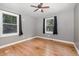 Bedroom featuring hard wood floors, two windows with drapes, and neutral paint at 500 Ellen Dr, Knightdale, NC 27545