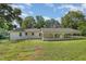 This home's exterior displays a spacious lawn leading to a covered patio at 500 Ellen Dr, Knightdale, NC 27545