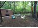 Secluded backyard featuring a fire pit and outdoor seating, surrounded by mature trees at 5112 Stephens Ln, Durham, NC 27712