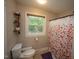 Bright bathroom with a floral shower curtain, window and neutral tones at 5112 Stephens Ln, Durham, NC 27712
