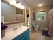 Bathroom featuring a large mirror, a blue vanity, and tile flooring at 5112 Stephens Ln, Durham, NC 27712