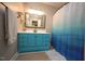 Updated bathroom with a blue vanity and colorful shower curtain at 5112 Stephens Ln, Durham, NC 27712