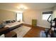 Comfortable bedroom featuring hardwood floors, natural light, and neutral paint at 5112 Stephens Ln, Durham, NC 27712