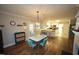 Cozy dining area boasts hardwood floors, retro furniture, and convenient access to the kitchen at 5112 Stephens Ln, Durham, NC 27712