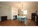 Bright dining area with hardwood floors, unique light fixture, and a tiled fireplace at 5112 Stephens Ln, Durham, NC 27712