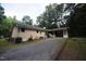 Exterior view of a charming home with a long driveway and a covered carport at 5112 Stephens Ln, Durham, NC 27712